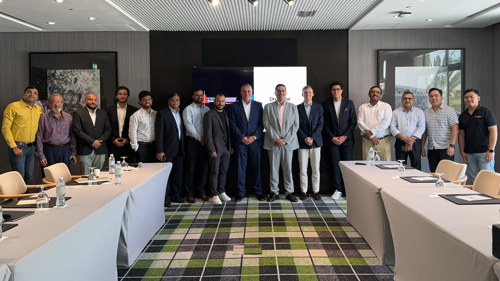 PRO TECHnology and Dropbox teams with media-sector guests standing before the Dropbox screen at the Address Montgomerie Dubai event on 29 May 2024