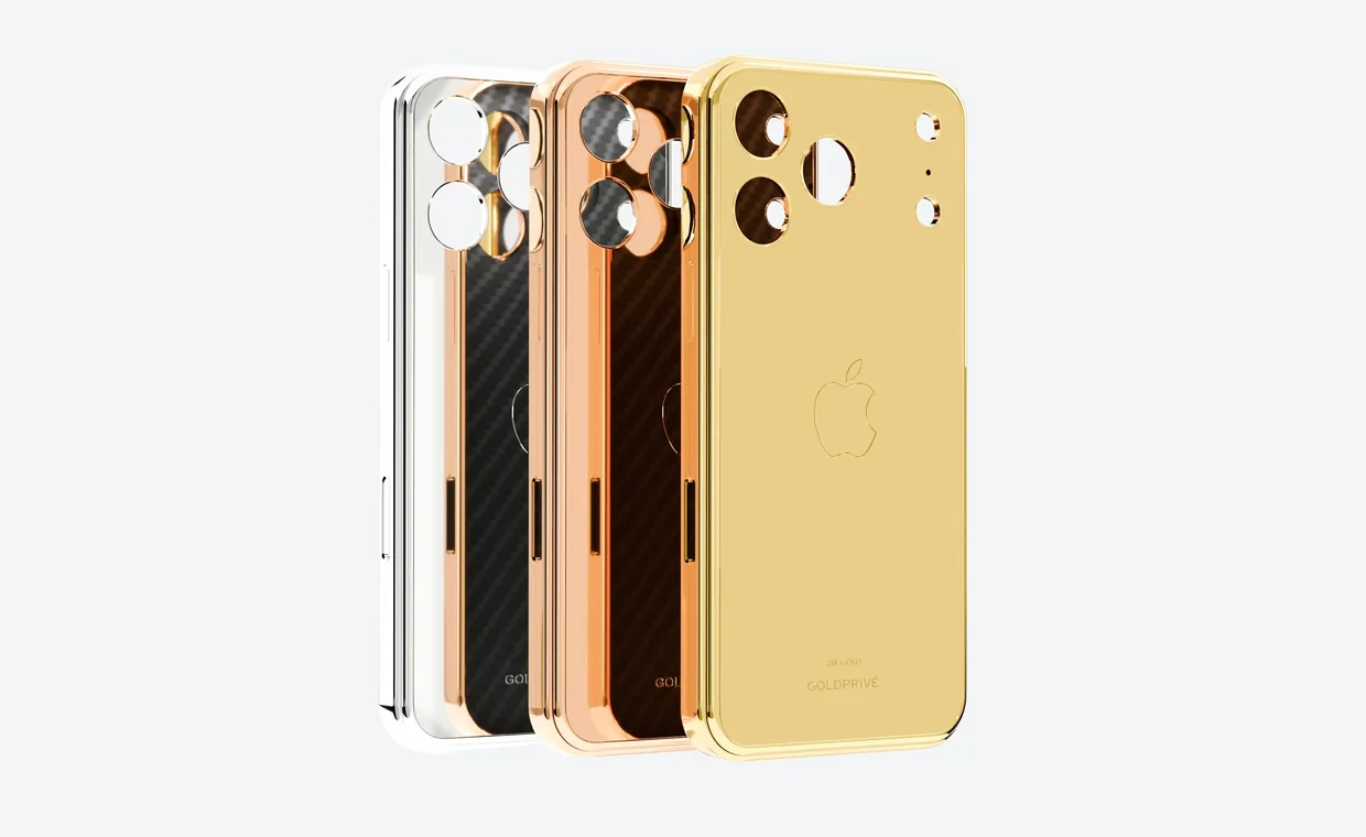 Three GoldPrivé iPhone backs fanned out on a light grey background: one plated in platinum with a black carbon fibre panel, one in rose gold with a brown carbon fibre panel, and one in plain polished 24K gold showing the Apple logo and a small GoldPrivé mark near the bottom.