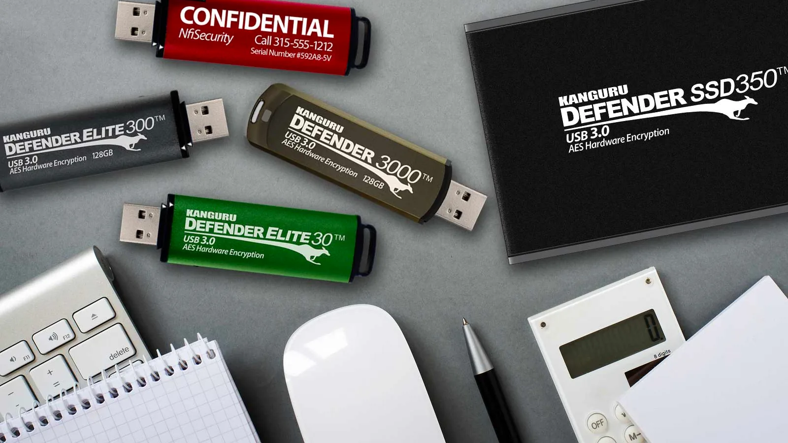 Kanguru Defender 3000, Defender Elite 300 and Elite 30 encrypted USB flash drives, a Defender SSD350 and a custom-printed drive on an office desk