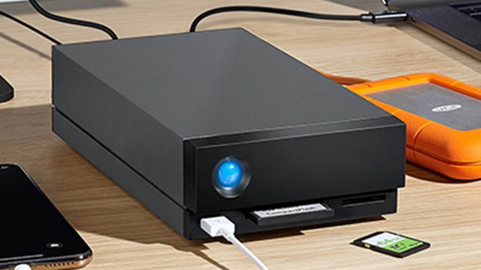 LaCie professional storage on an editing desk with a dock, card reader and rugged portable drive