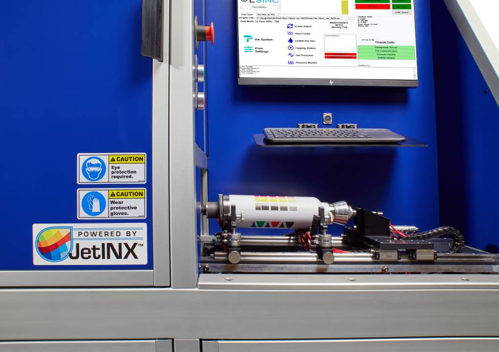 LSINC cylindrical UV printer decorating a glass perfume bottle in Dubai