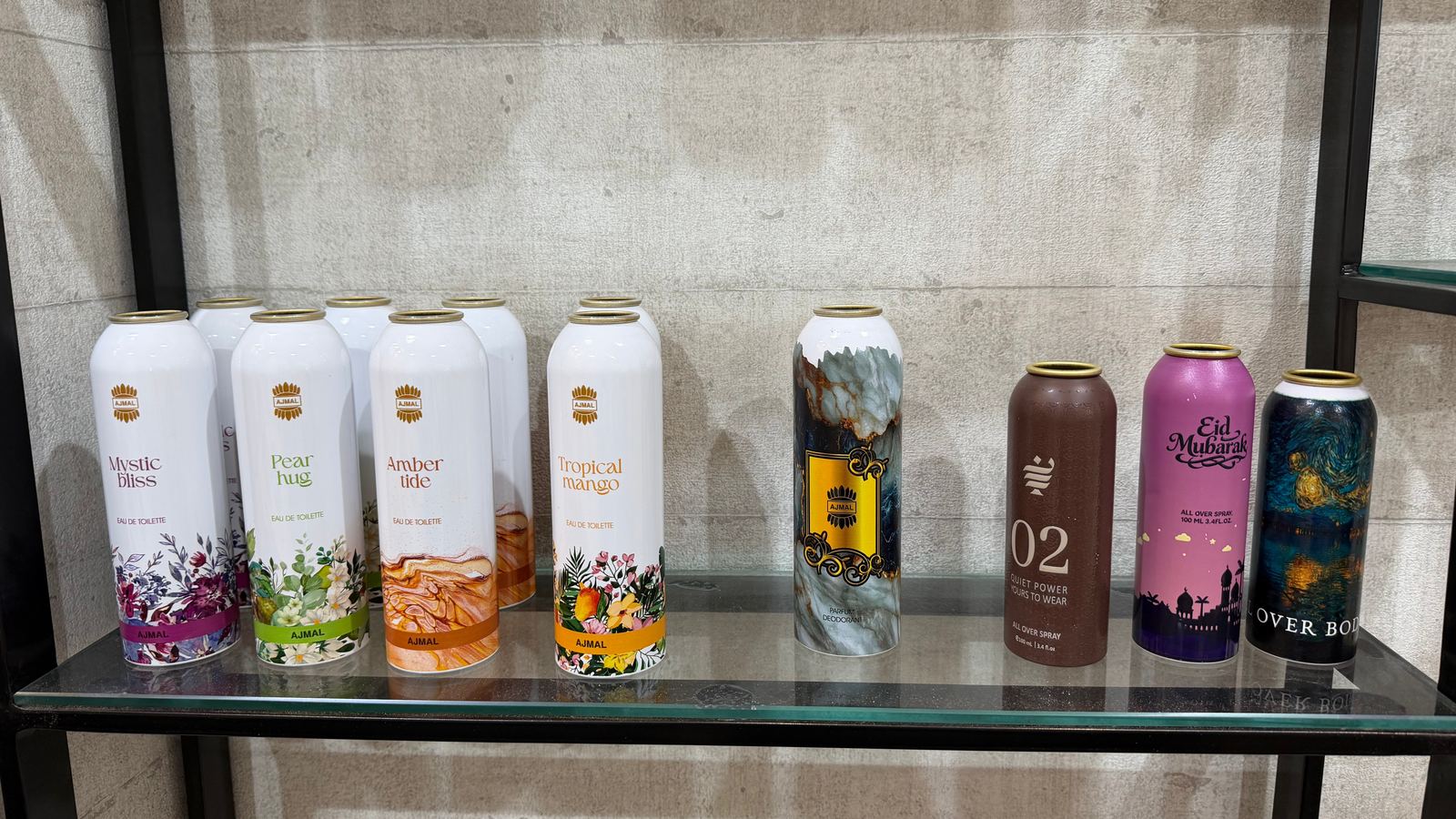 Directly printed eau de toilette and all-over body spray cans on a sample shelf in Dubai