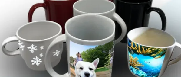 Printed handled ceramic mugs in white, red and black, one with a photograph of a dog wrapped round the body, one with white snowflakes and one with an underwater coral scene
