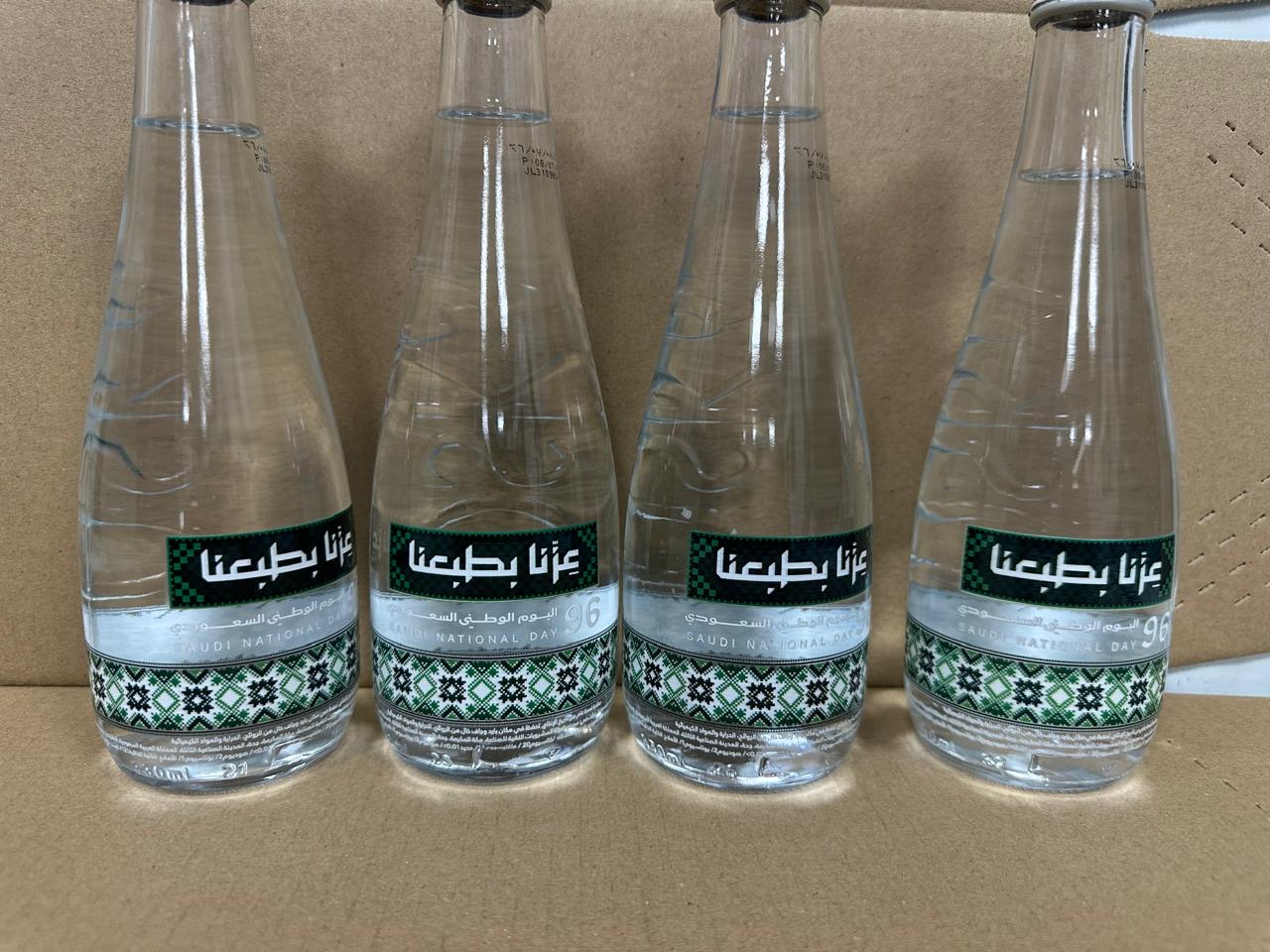OSKA glass water bottles from Pure Beverages Industry Company, each decorated with a patterned band printed directly onto the glass
