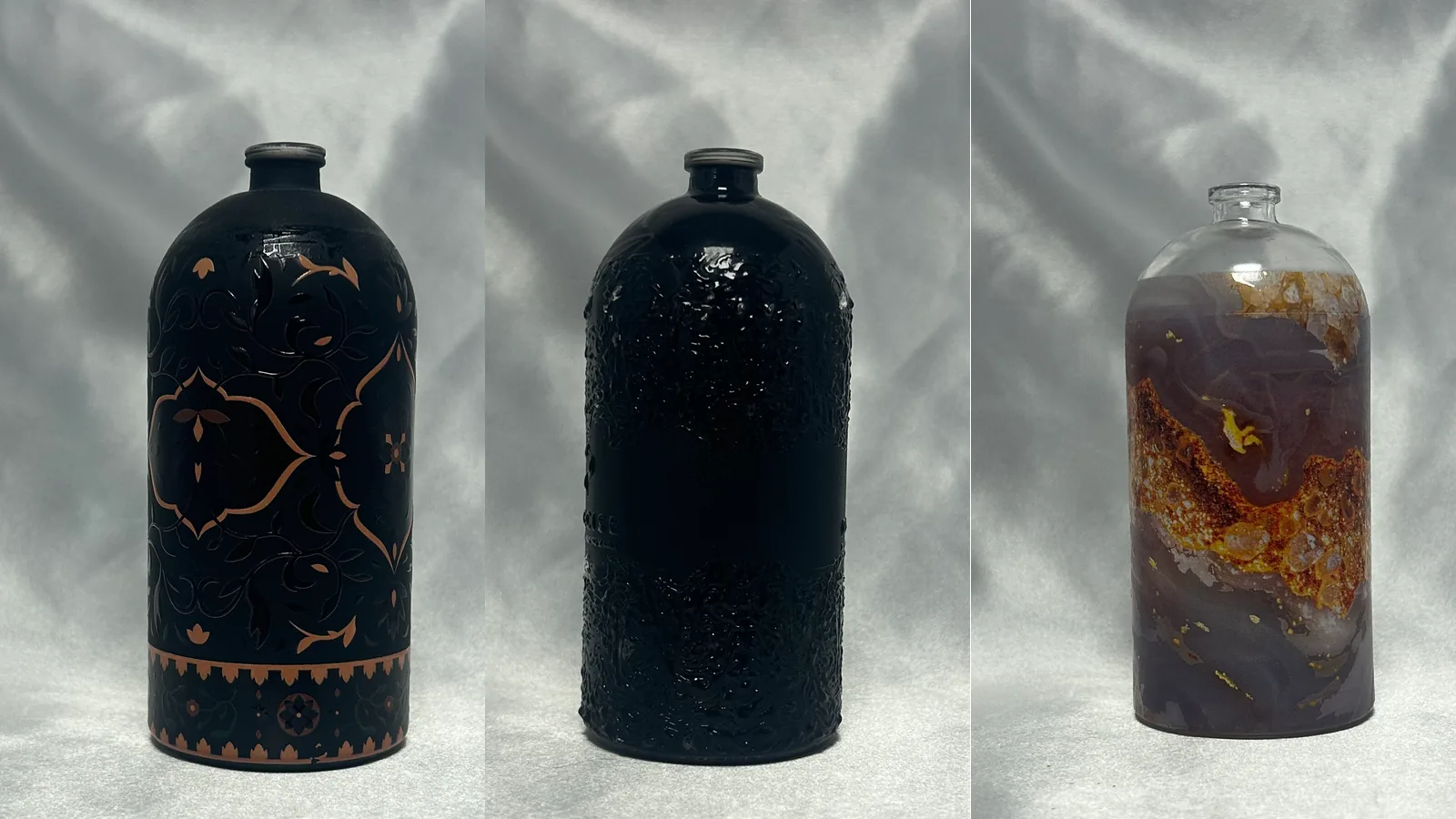 Three round perfume bottles printed all round: a black and copper arabesque, a raised black texture, and a purple and amber marble effect