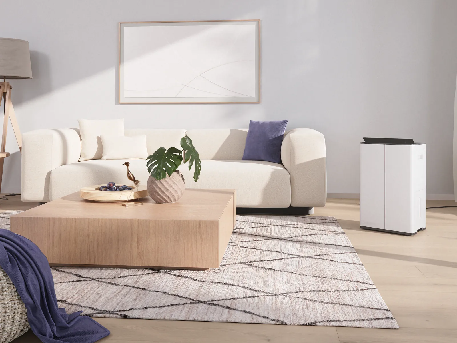 Stadler Form Lukas dehumidifier in a bright living room beside a cream sofa and a wooden coffee table