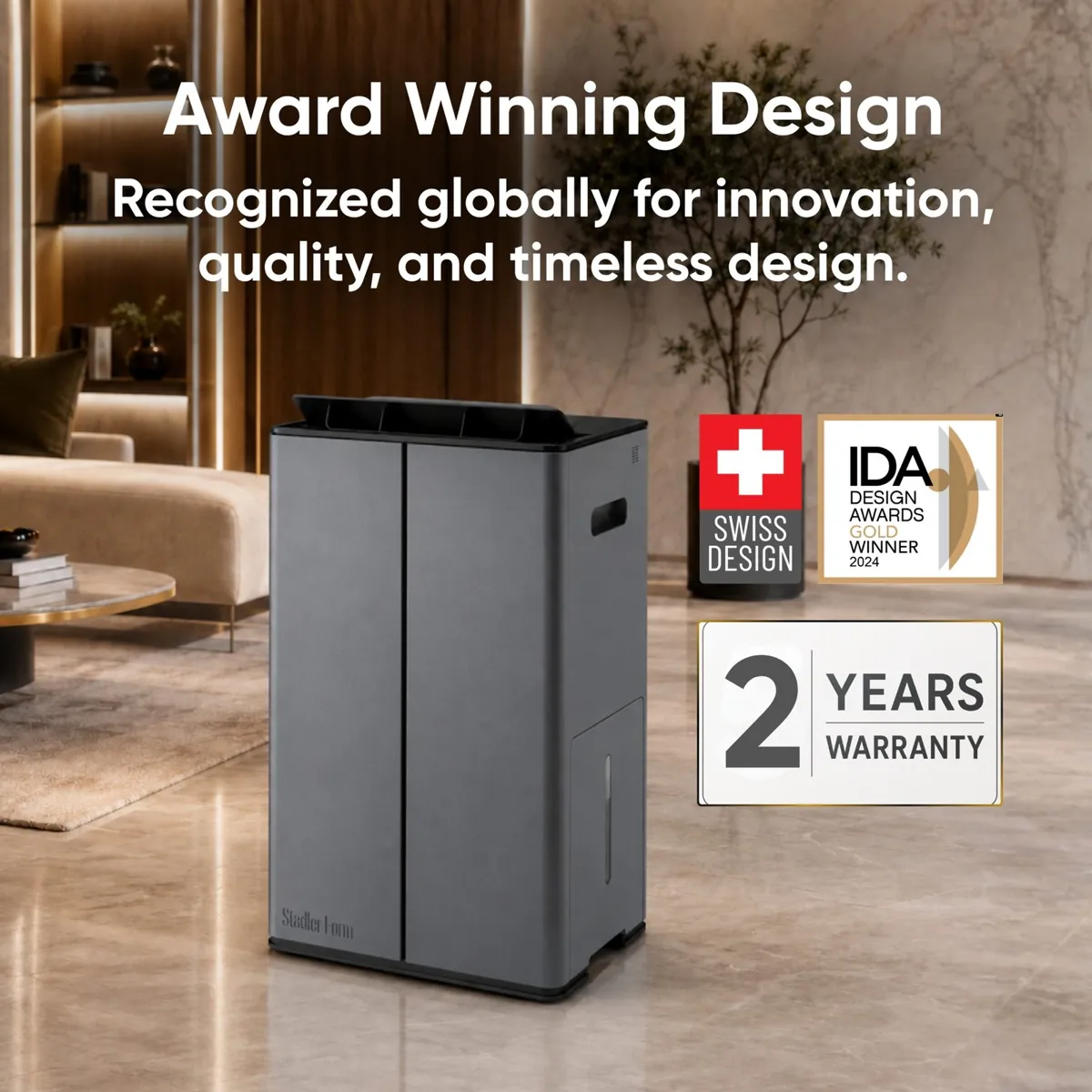 Stadler Form Lukas Titanium in titanium grey in a living room, beside Swiss design, IDA Design Awards 2024 and 2-year warranty badges