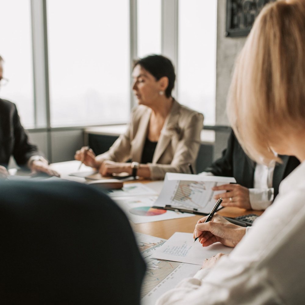 A team reviewing schedules around a meeting table