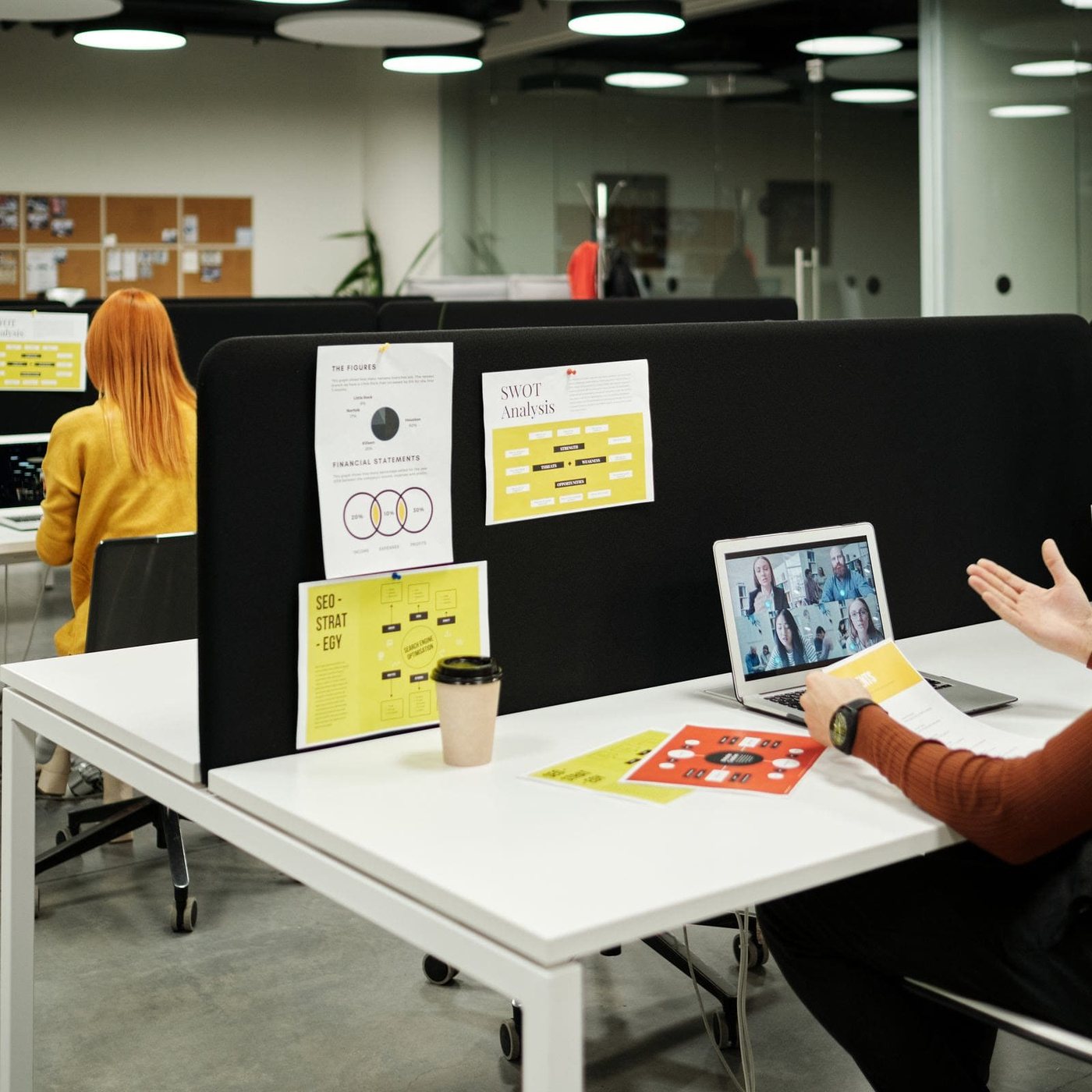 An open-plan office with staff working at shared desks