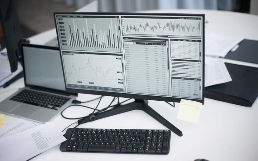 An orderly desk with call-review dashboards on screen